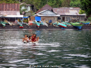 Children of Tandurusa Village playing on a makeshift raft... by Pauline Walsh Jacobson 
